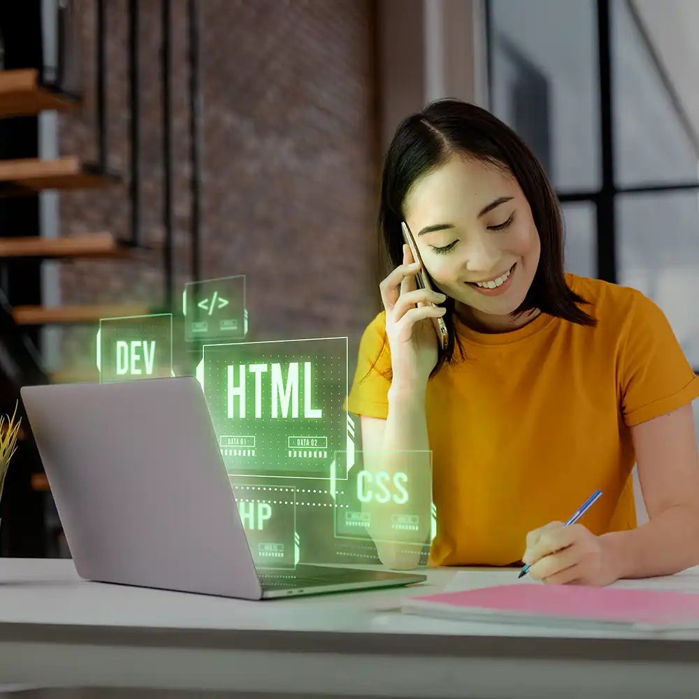 A woman smiling while making a phone call, with her laptop displaying a glowing HTML hologram.