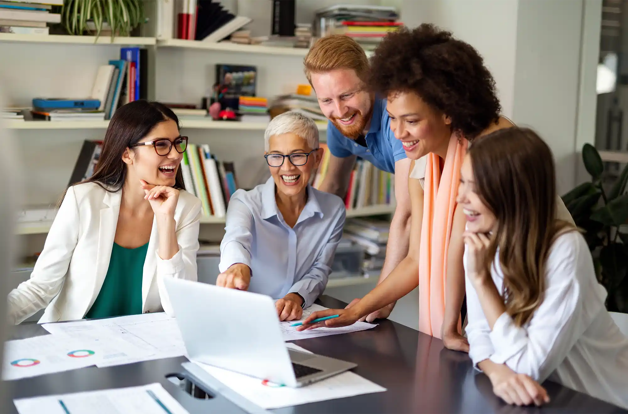 A group of co-workers in a meeting discussing marketing & digital solutions strategies